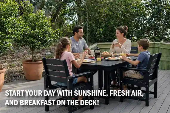 Family enjoying breakfast together on outdoor deck at Sonoma’s Hideaway in Corolla Outer Banks with sunshine, fresh air, and relaxing vacation atmosphere
